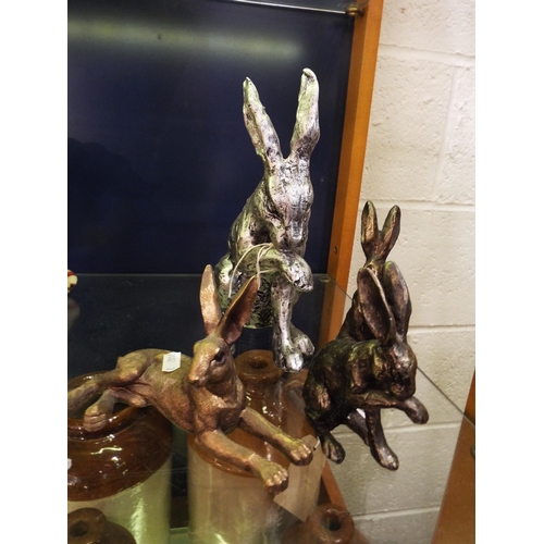 97 - A group of four resin figures of Hares