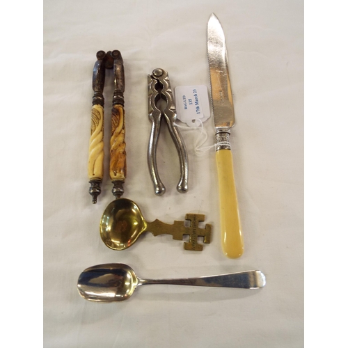 135 - Two pairs of nutcrackers, silver spoon, caddy spoon and cake knife