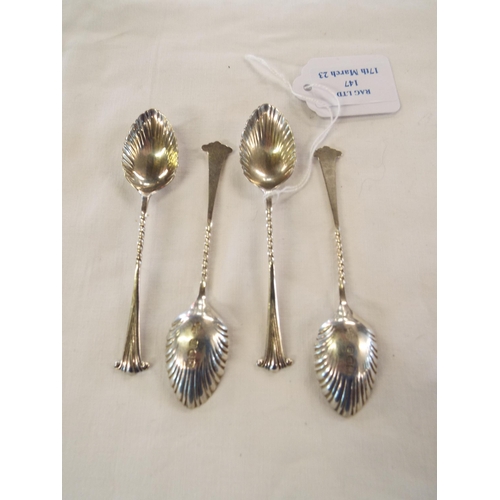 147 - A set of four London 1927 silver teaspoons with scroll finials barley twist stem and shell bowls