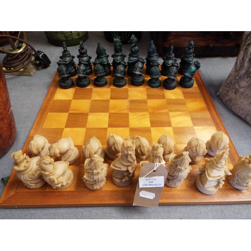 245 - A resin Knights chess set and board