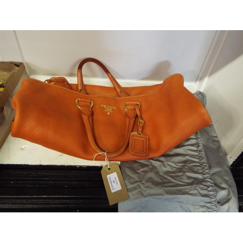 369 - A Prada orange leather handbag and dust cover