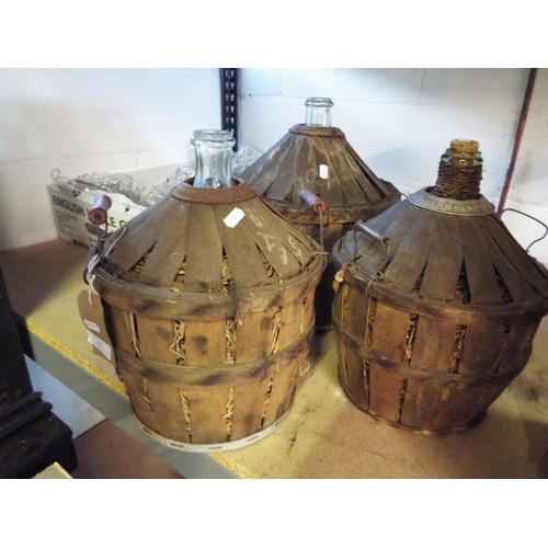 349 - Three vintage demijohns in wicker covers