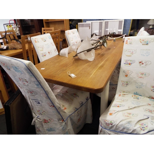 516 - An oak top and white painted kitchen table with six chairs with loose covers