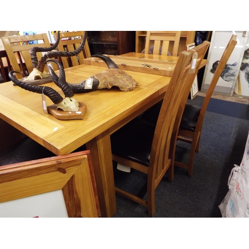 517 - An oak extending dining table with two leaves and six chairs