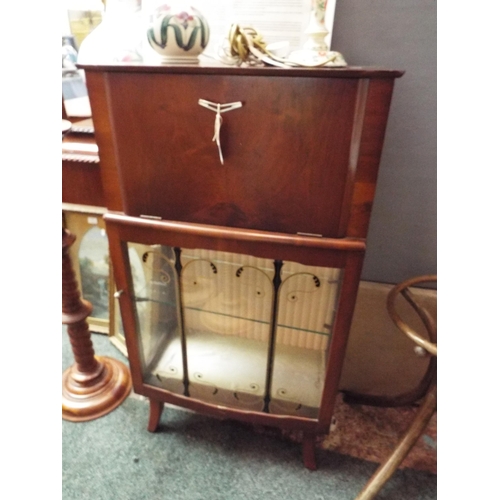 540 - A retro mahogany cocktail cabinet the hinged flap enclosing glass shelf above a glazed door