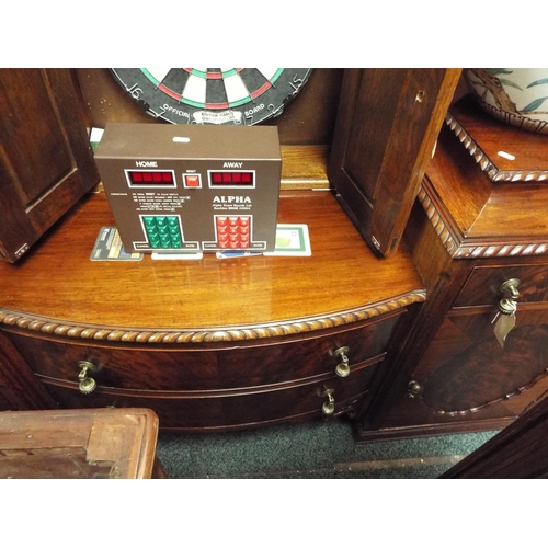 555 - A mahogany bow-front sideboard having two central drawers flanked by two short drawers and cupboards