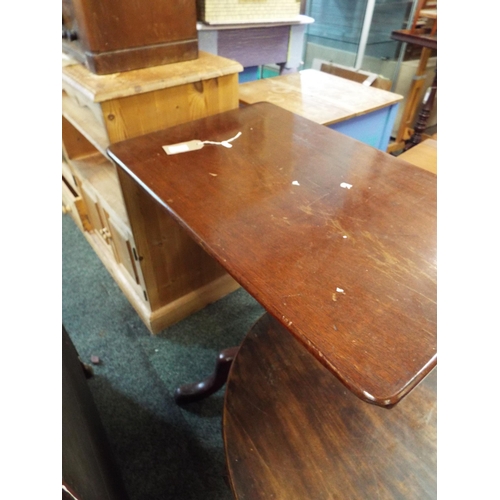 601 - A mahogany oblong snap top side table resting on tri-form base