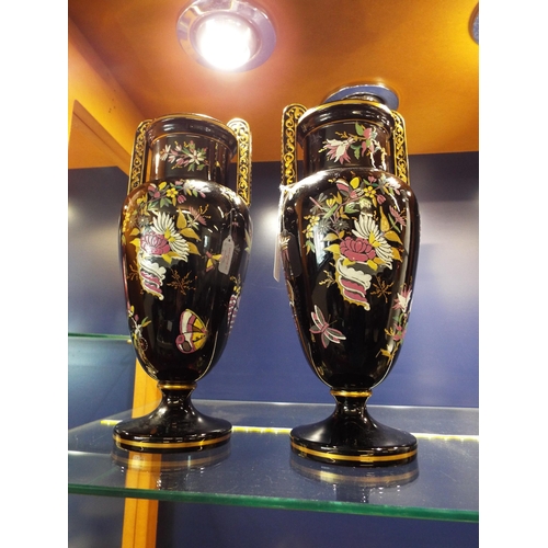 47 - A pair of black ground vases having gilt, floral and insect decoration