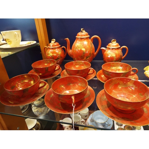 49 - A Japanese eggshell tea-set with red glaze and gilt dragon decoration signed to base