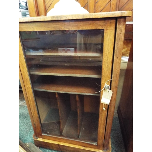 672 - A walnut and satin wood inlaid music cabinet with glazed door enclosing shelves and compartments