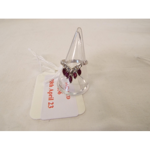 256 - A silver tiara shaped ring inset with five rubies, size N