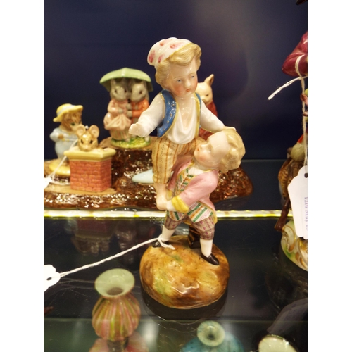 11 - A Saxony pottery figurine of two young boys