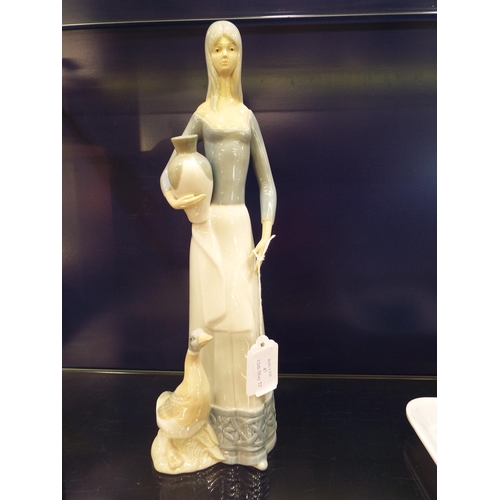 47 - A Valencia figurine of a female water carrier and duck