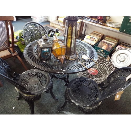 612 - A black painted metal garden table and three chairs