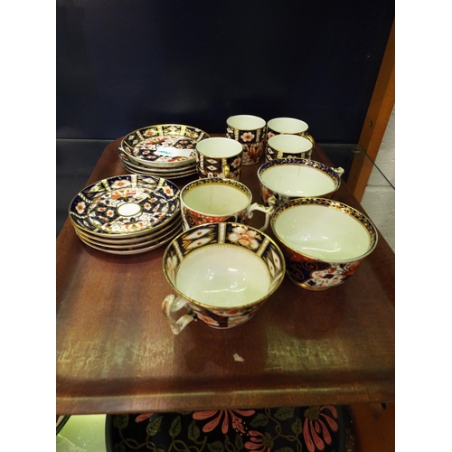 111 - A selection of Crown Derby cups, mugs and saucers