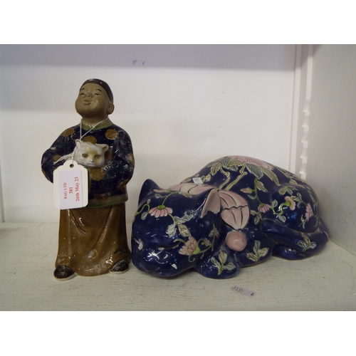 381 - An Oriental blue glazed cat and a Japanese mud figure man with cat