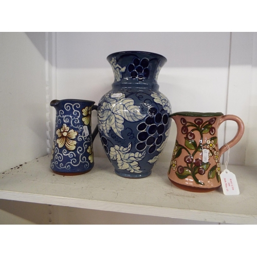 395 - Two glazed terracotta jugs and a vase