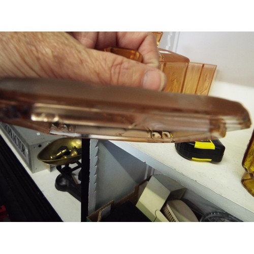 388 - A pair of pink glass art deco lidded jars with embossed female decoration