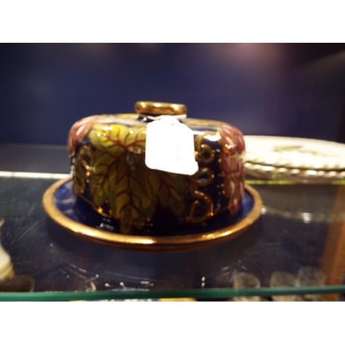 63 - A rare Wendy Mason of Shrewsbury cheese dome with grape and vine decoration and gilt banding