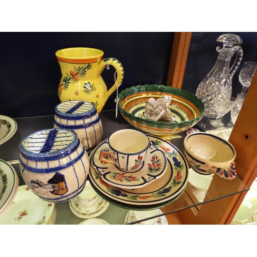 69 - A selection of Quimper barrels, yellow jug, porringer, cup and saucer, plates and small vase