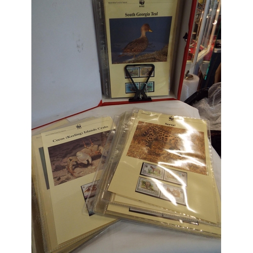 83 - A box of seventy three animal sets of four un-mounted mint stamps on display sheets