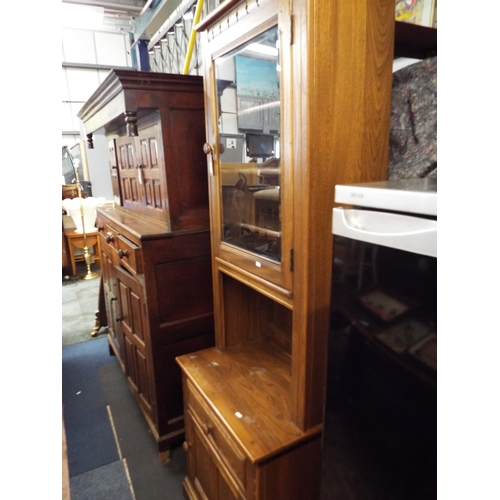 550 - An Ercol narrow glass display cabinet above a short drawer with cupboard under