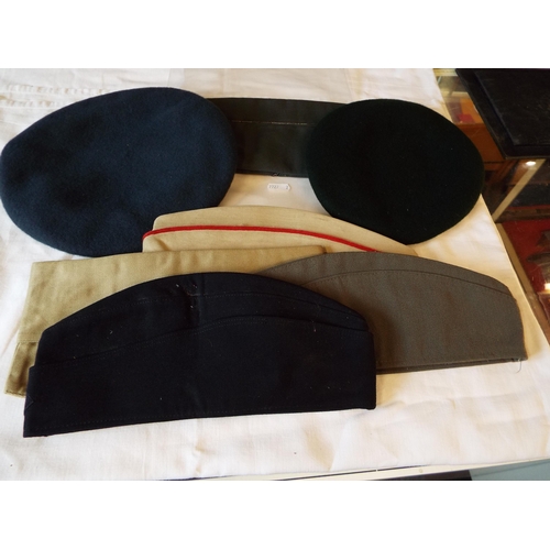 109 - A selection of military hats to include berets