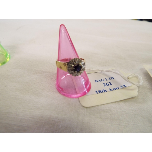 262 - A 9ct gold ring inset with central sapphire flanked by diamonds, size N