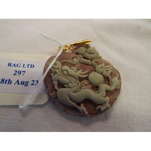 297 - A carved jade pendant have dragon chasing the pearl of wisdom decoration and yellow metal bail