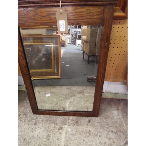 498 - A vintage oak framed bevelled glass mirror