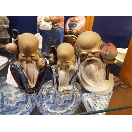 26 - Three Chinese mud figurines of sage's