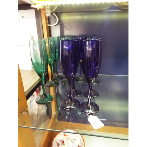 130 - A set of six Oxford blue wine glasses and five green wine glasses