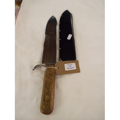 178 - A vintage bowie style knife in metal scabbard