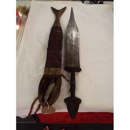 180 - An early 20thC African (Cameroon) knife having engraved blade, leather hilt guard and grip in a leat... 