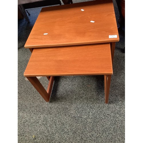 544 - A nest of two teak side tables