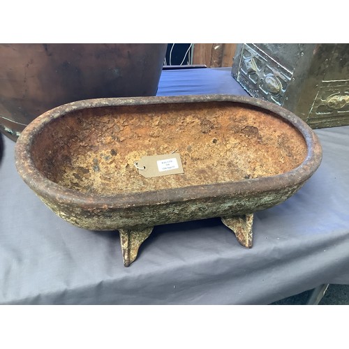 539 - An antique cast iron water trough