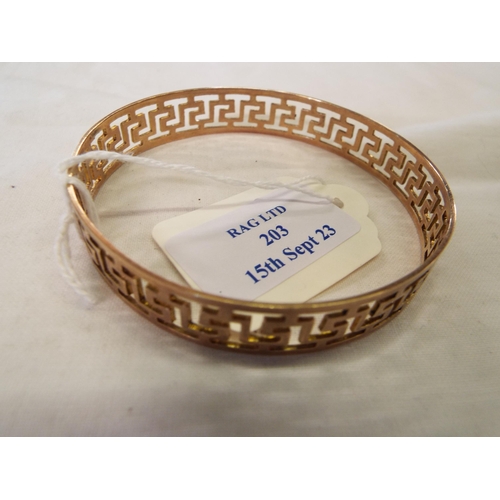 203 - A 9ct gold bangle having Greek Key design, weighing 21.5g