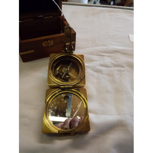 229 - A reproduction Stanley of London Natural Sine compass housed in a wooden and brass inlaid box