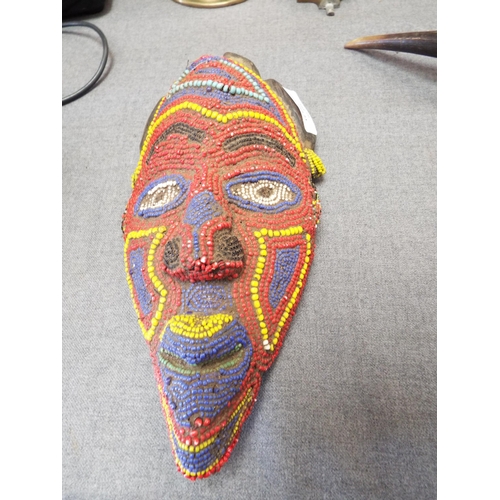 295 - A late 19th early 20thC facemask from the Cameroon having vibrant colour and varied shape