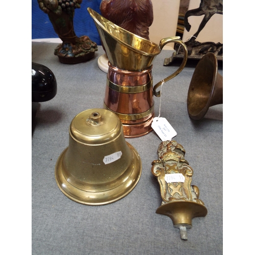 297 - A copper and brass jug together with a brass bell and a Heraldic brass lion