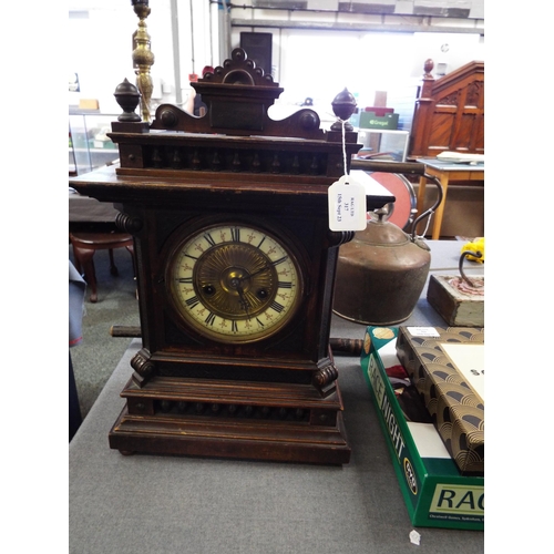 317 - An oak cased mantel clock with Roman numerals, bezel A/F