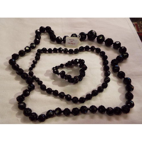 244 - Two black beaded necklaces and matching bangle