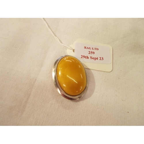 259 - A 925 silver honey coloured amber brooch