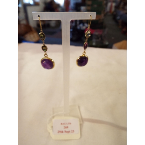 269 - A pair of earrings inset with amethyst stones