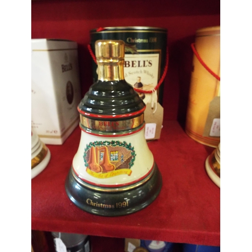 293 - A unopened Extra Special Bells Whisky decanter commemorating Christmas 1991 housed in a tin