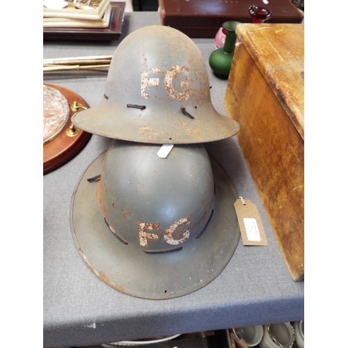 338 - Two WWII British Army helmets marked FG