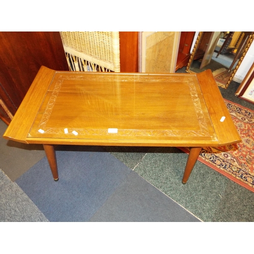 582 - A mid-century carved and glass top coffee table