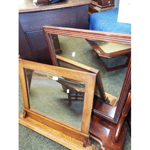 600 - A Victorian mahogany dressing table mirror together with an oak mirror