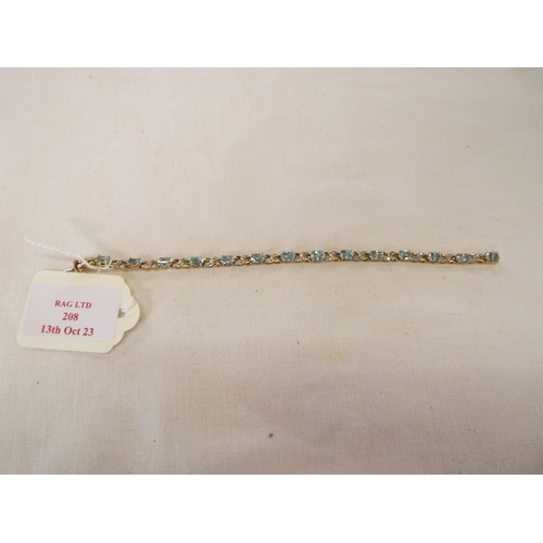 208 - A 9k gold tennis bracelet inset with aquamarine stone flanked by diamonds,