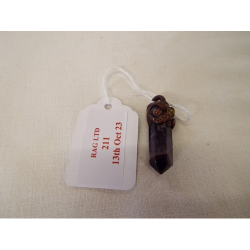 211 - An amethyst pendant drop with carved face to top